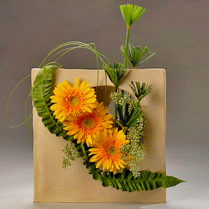 yellow gerbera and papyrus arrangement in a home made ceramic container designed by marieLn 